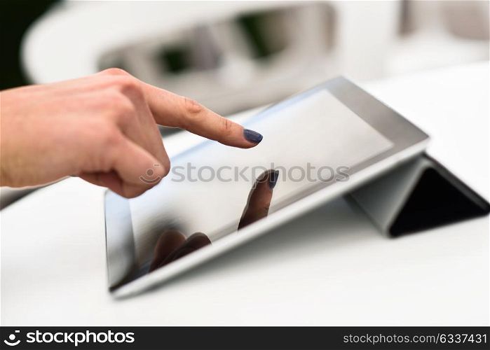Close-up of a woman&rsquo;s hand touching a tablet computer