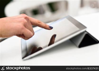 Close-up of a woman&rsquo;s hand touching a tablet computer