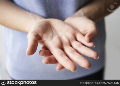 Close Up of a Woman rubbing her hands together