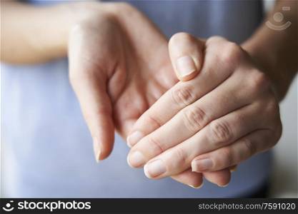 Close Up of a Woman rubbing her hands together with disinfectant