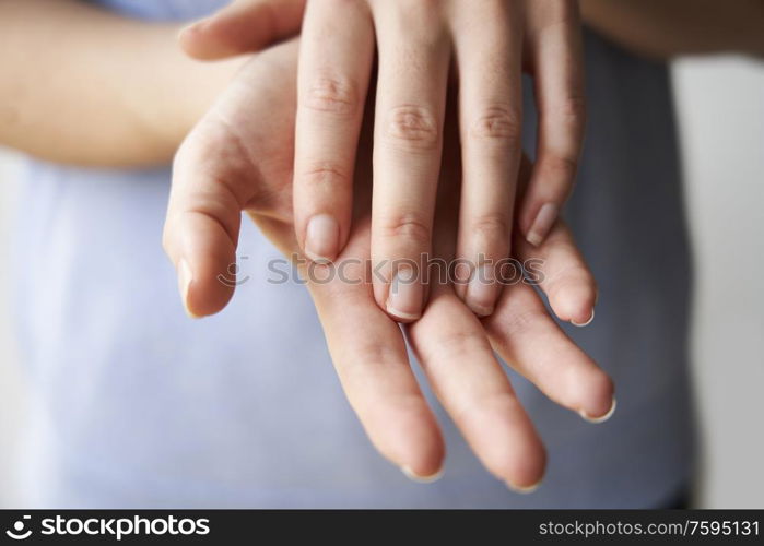Close Up of a Woman rubbing her hands together with disinfectant