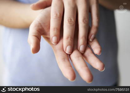 Close Up of a Woman rubbing her hands together with disinfectant