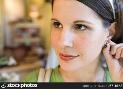 Close up of a woman touching her ear