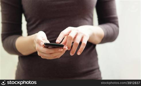 Close up of a woman using mobile smart phone