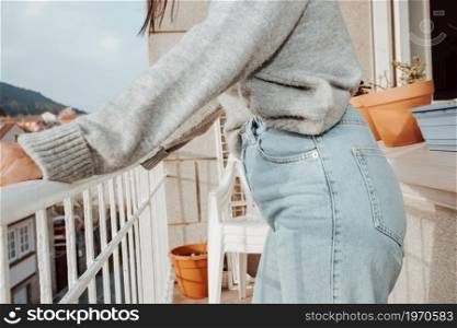 Close up of a woman wearing mom jeans with copy space during a bright day, fashion and styling concept