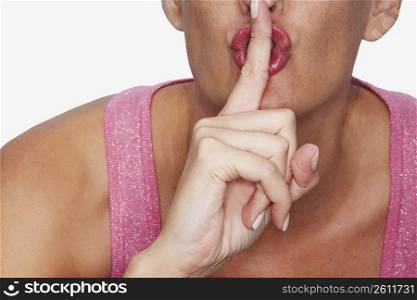 Close-up of a woman with her finger on her lips