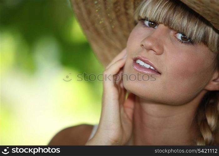 close-up of a woman with straw hat
