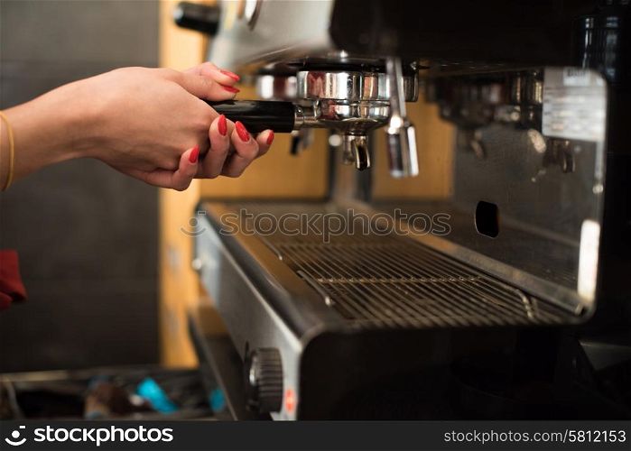 Close up of a woman working with a expresso machine