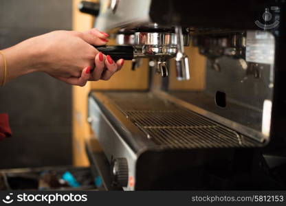 Close up of a woman working with a expresso machine