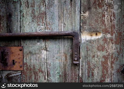 Close-up of a wooden door with a latch