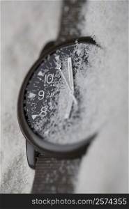 Close-up of a wristwatch in sand