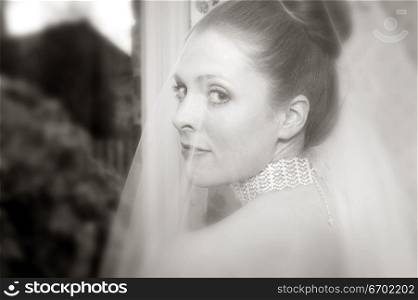 Close-up of a young bride looking over her shoulder ( black and white )