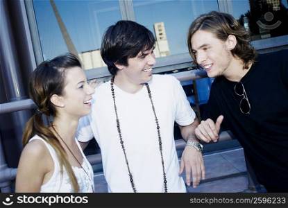 Close-up of a young couple and a teenage boy smiling