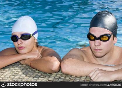 Close-up of a young couple at the edge of a swimming pool