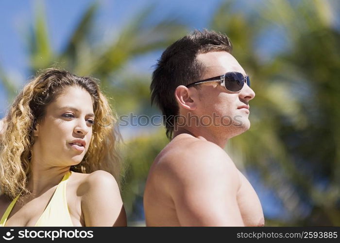 Close-up of a young couple back to back