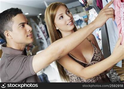 Close-up of a young couple choosing clothes in a store