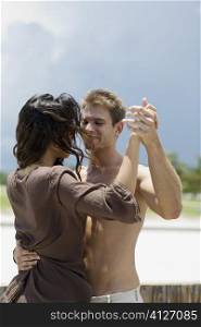 Close-up of a young couple dancing on the beach