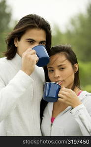 Close-up of a young couple drinking coffee