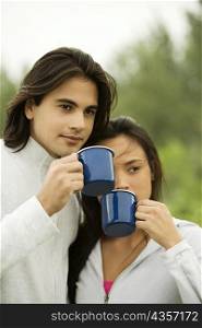Close-up of a young couple drinking coffee