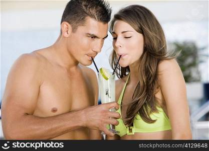 Close-up of a young couple drinking lemonade