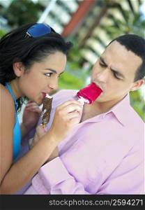 Close-up of a young couple eating ice cream