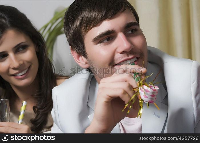 Close-up of a young couple enjoying a birthday party