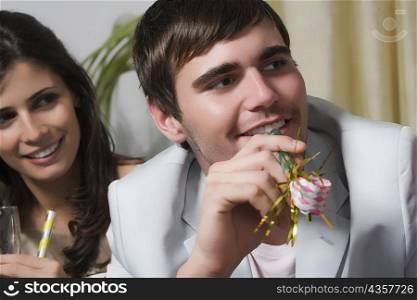 Close-up of a young couple enjoying a birthday party