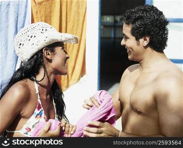 Close-up of a young couple holding a towel and smiling