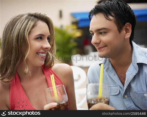 Close-up of a young couple holding glasses of cold drinks
