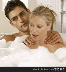 Close-up of a young couple in a bubble bath