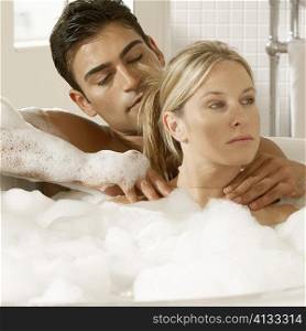 Close-up of a young couple in a bubble bath