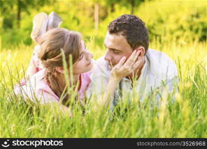 Close-up of a young couple in love on grass