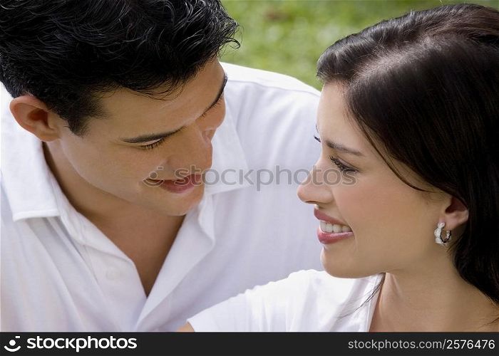 Close-up of a young couple looking at each other and smiling