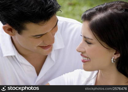 Close-up of a young couple looking at each other and smiling