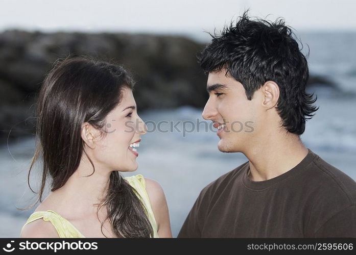 Close-up of a young couple looking at each other and smiling