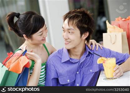 Close-up of a young couple looking at each other and smiling