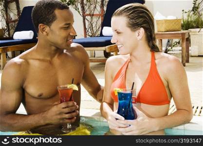 Close-up of a young couple looking at each other in a swimming pool