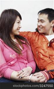 Close-up of a young couple looking at each other smiling