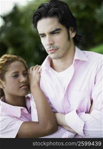 Close-up of a young couple looking upset