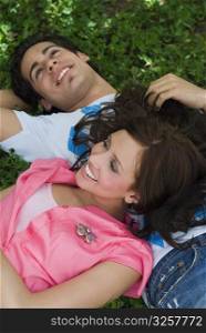 Close-up of a young couple lying in a park