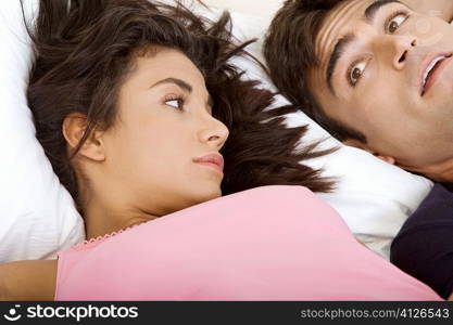 Close-up of a young couple lying on the bed