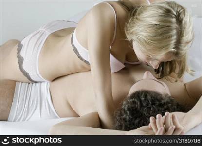 Close-up of a young couple romancing on the bed