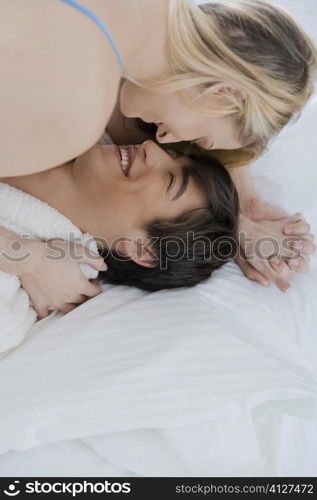 Close-up of a young couple romancing on the bed