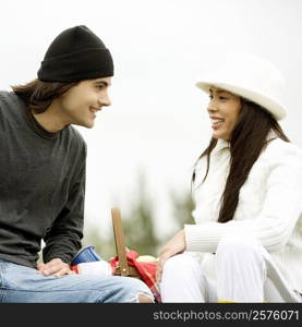 Close-up of a young couple sitting and smiling