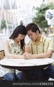 Close-up of a young couple sitting in a cafeteria