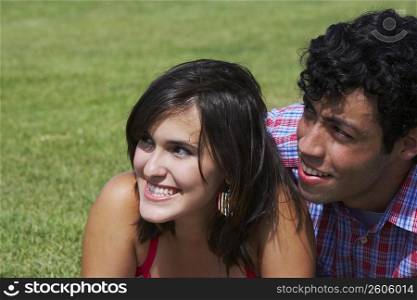 Close-up of a young couple smiling and looking away