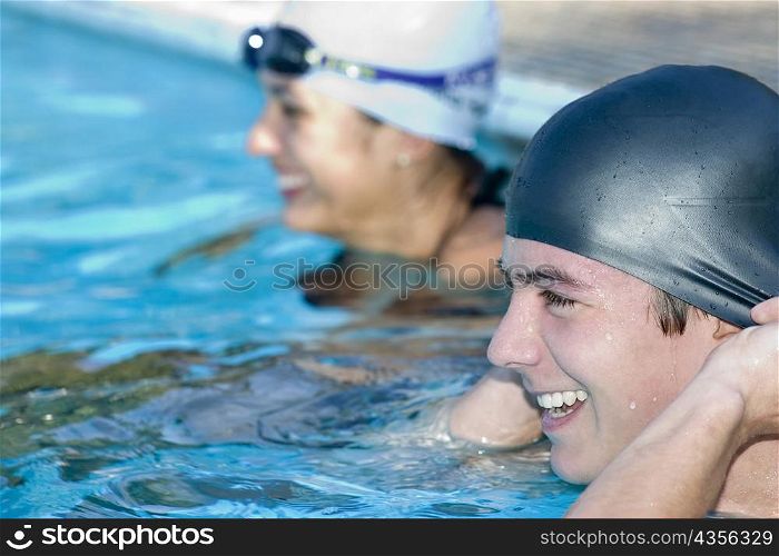 Close-up of a young couple smiling in a swimming pool