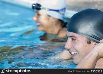 Close-up of a young couple smiling in a swimming pool
