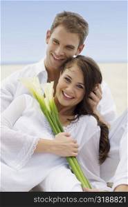 Close-up of a young couple smiling on the beach