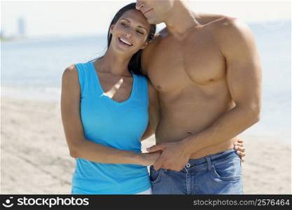 Close-up of a young couple standing on the beach